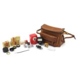 Vintage tan leather camera bag with camera accessories including Rollei