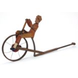 Novelty wooden push along penny farthing with rider and bell, 68cm in length