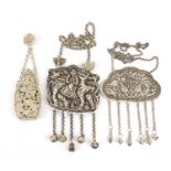 Two Chinese silver coloured metal embossed pendants and a chatelaine scent bottle, the largest