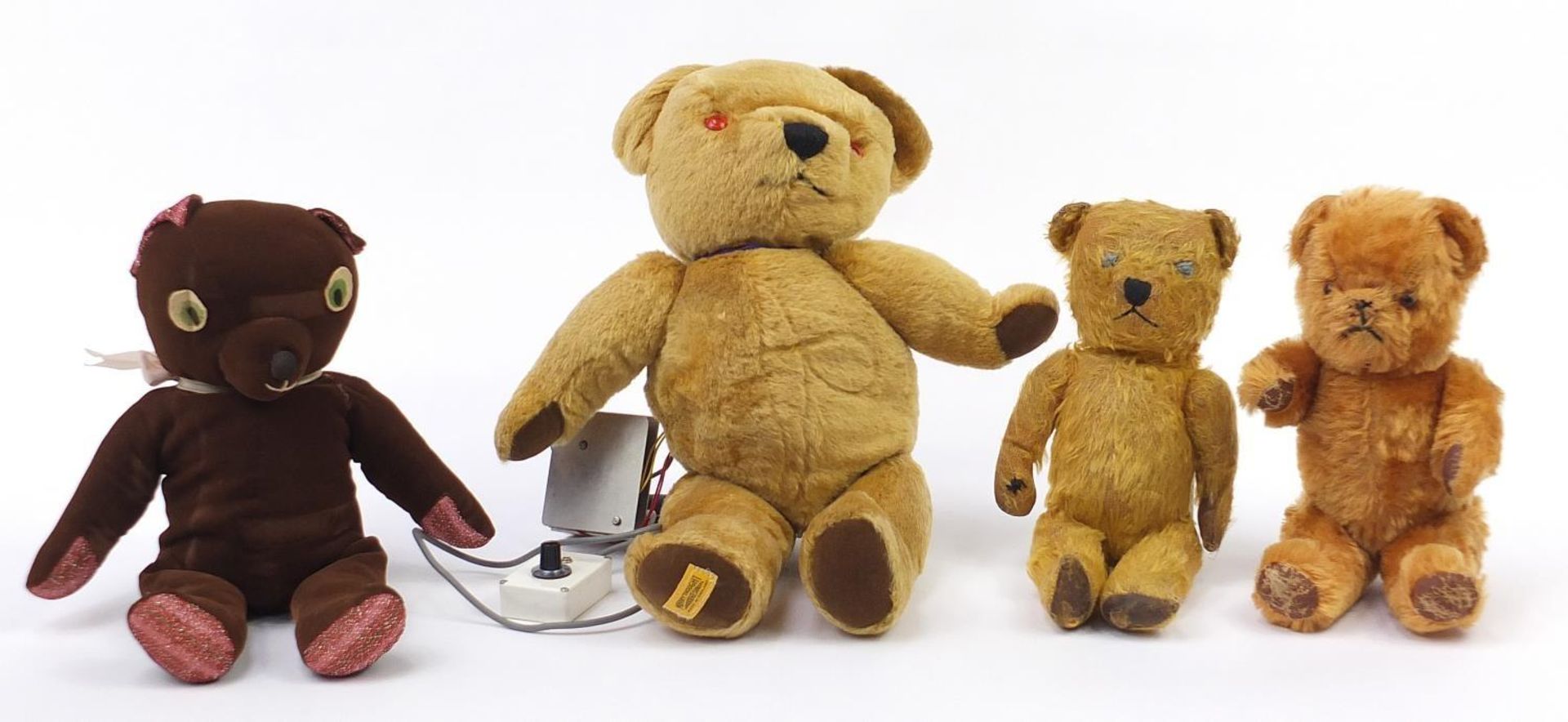 Four Antique and later bears including two straw filled and a Merrythought example, the largest 48cm