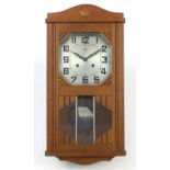 French Art Deco oak wall clock with silvered dial having Arabic numerals, 61.5cm high