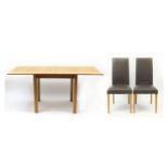 Contemporary light oak extending dining table and two brown faux leather chairs, the table 76cm H