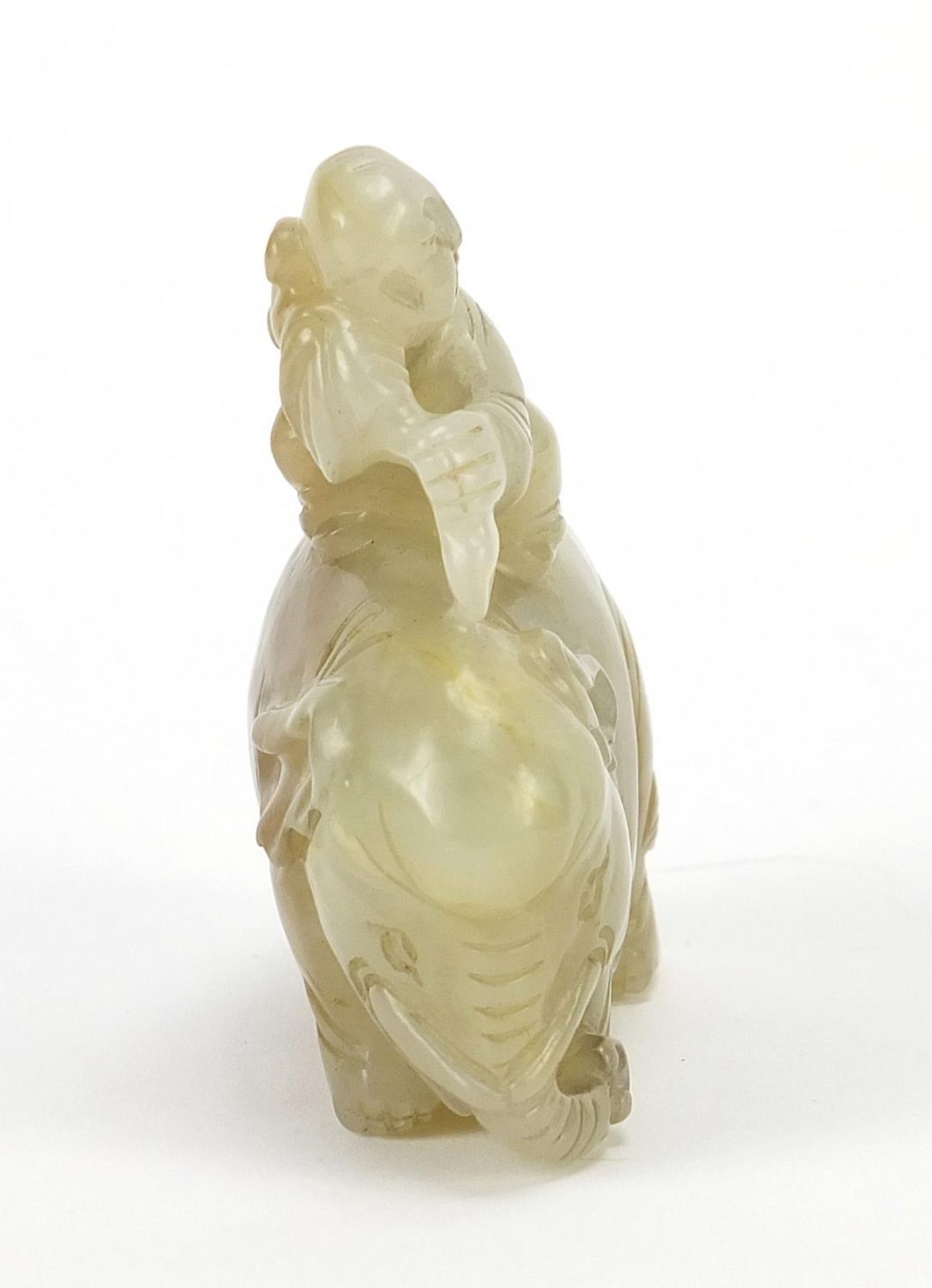 Chinese celadon and russet jade carving of a boy holding a ruyi sceptre on elephant, 6.5cm wide - Image 5 of 7