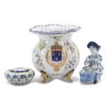 French faience glazed pottery including a four footed vase hand painted with a coat of arms and a