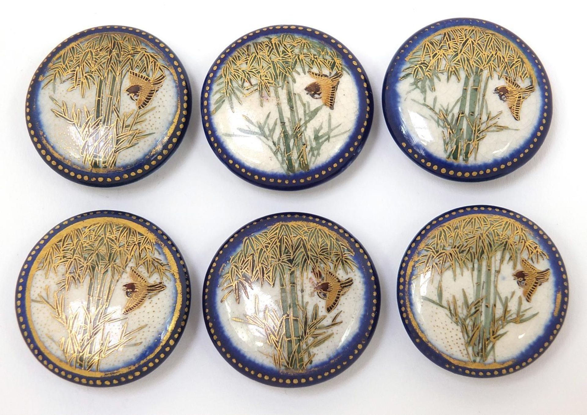 Set of six Japanese Satsuma pottery buttons, each hand painted with a bird amongst bamboo grove,