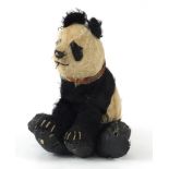 Antique straw filled panda with leather collar, 38cm in length