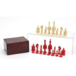 19th century carved bone half stained chess set, the largest pieces each 9.5cm high