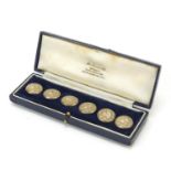 Abel & Charnell, set of six Art Nouveau silver buttons, embossed with a maiden's head, housed in a J
