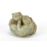 Good Chinese celadon and russet jade carving of two mythical animals, 4.5cm wide