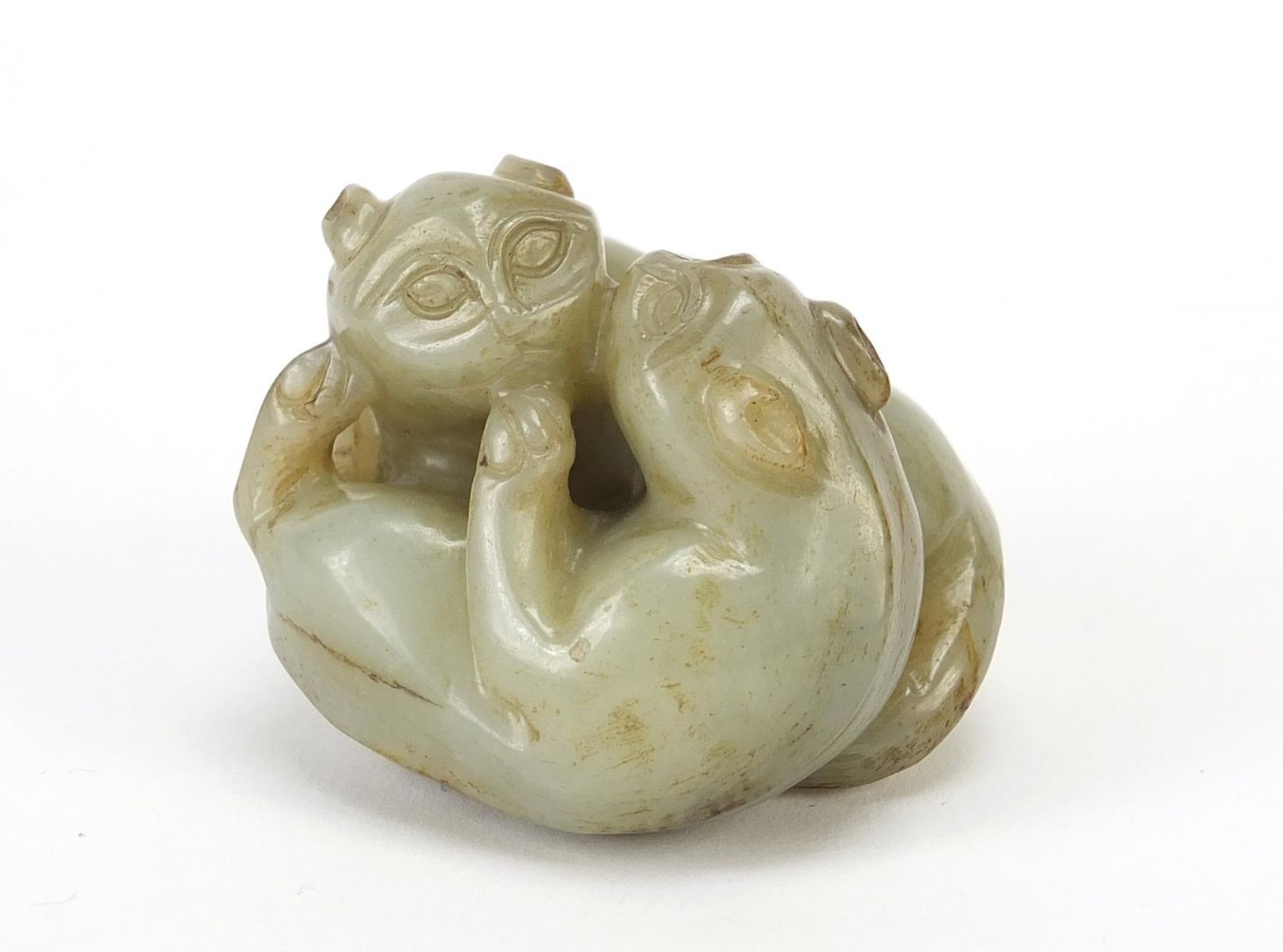 Good Chinese celadon and russet jade carving of two mythical animals, 4.5cm wide