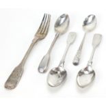 Four George III and later silver teaspoons and a Victorian silver fork, the largest 17cm in