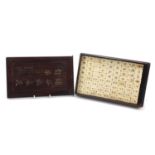 Chinese bone and bamboo mahjong set housed in a hardwood case, the case 26.5cm wide