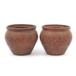 Pair of terracotta planters incised with foliate design, each 29.5cm high x 31.5cm in diameter