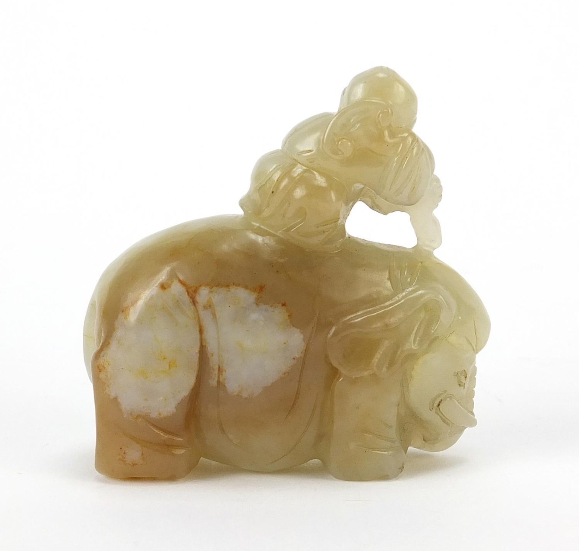 Chinese celadon and russet jade carving of a boy holding a ruyi sceptre on elephant, 6.5cm wide - Image 4 of 7