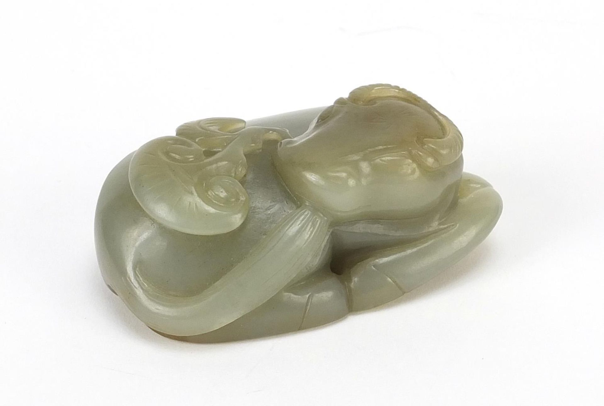 Chinese celadon and russet jade carving of a buffalo, 7cm wide