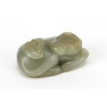 Chinese celadon and russet jade carving of a buffalo, 7cm wide