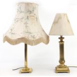 Two brass column table lamps with shades, the largest 80cm high