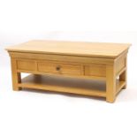 Contemporary light oak low table fitted with a double sided drawer above a shelf, 47cm H x 120cm W x