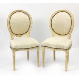 Pair of French style occasional chairs with cream upholstery and fluted legs, 101cm high