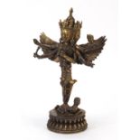 Chino Tibetan patinated gilt bronze figure of a mythical deity, 28.5cm high