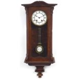 Mahogany wall clock with enamelled dial having Roman numerals, 76cm high