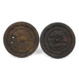 Pair of Afghan cast iron hand mirrors cast with fish, 16cm in diameter