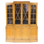Art Deco oak bookcase fitted with four glazed doors enclosing adjustable shelves above four panelled