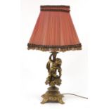 Ornate gilt metal Putti design table lamp with silk lined shade, 71cm high