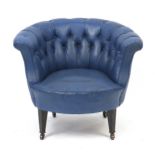 Mahogany framed tub chair with blue button back upholstery on brass casters, 68cm high