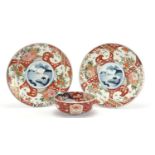 Japanese Imari comprising a pair of chargers hand painted with flowers and landscapes and a bowl,