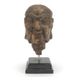 Chinese stucco head raised on a later stepped rectangular plinth base, 28.5cm high :