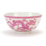 Chinese porcelain bowl hand painted in pink with a dragon and phoenix amongst clouds chasing a