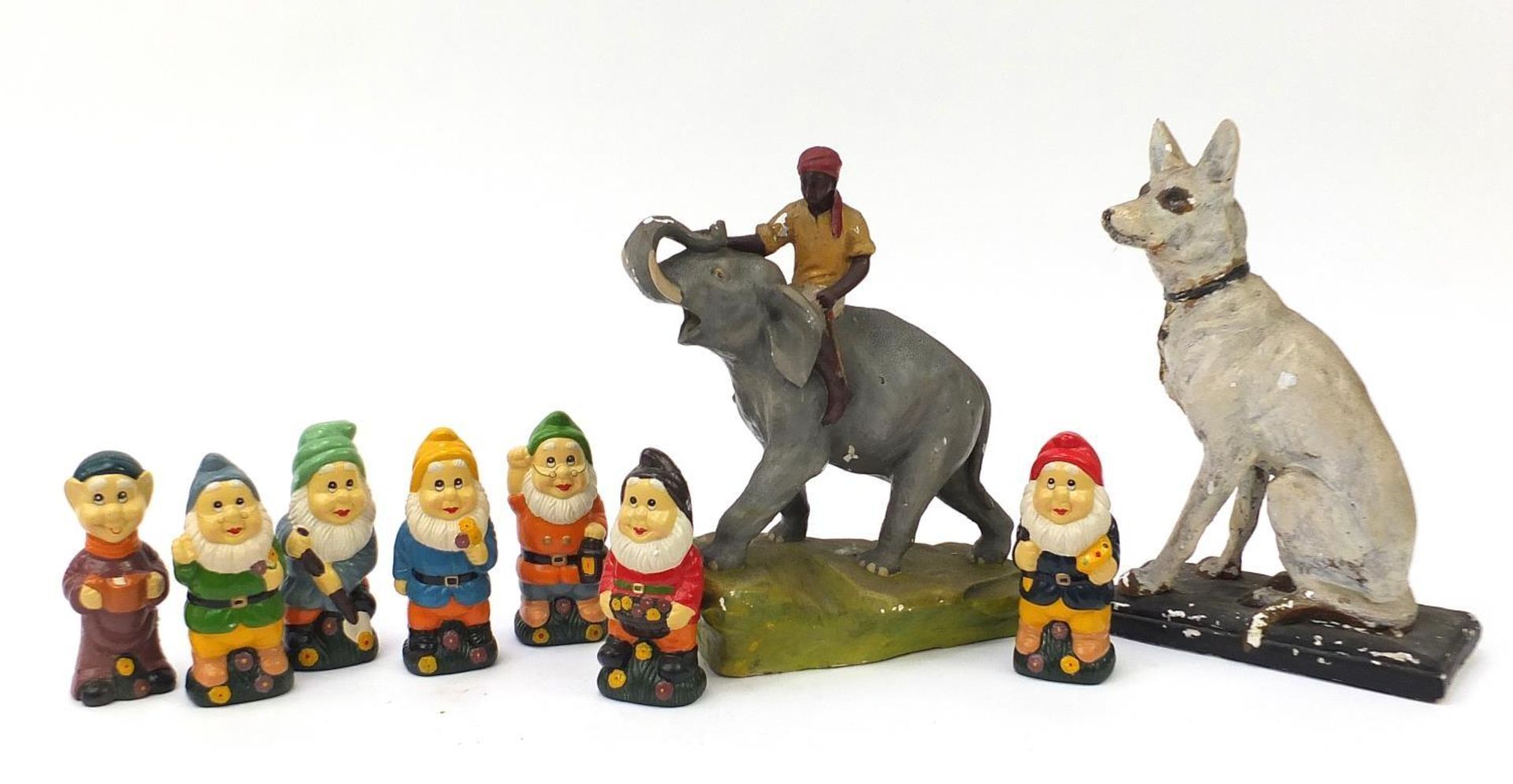 Hand painted plaster including figure on horseback and seven dwarfs, the largest 38cm high :
