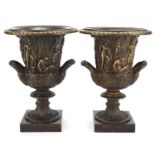 Large pair of patinated bronze campana urn vases with twin handles decorated with maidens, each 32cm