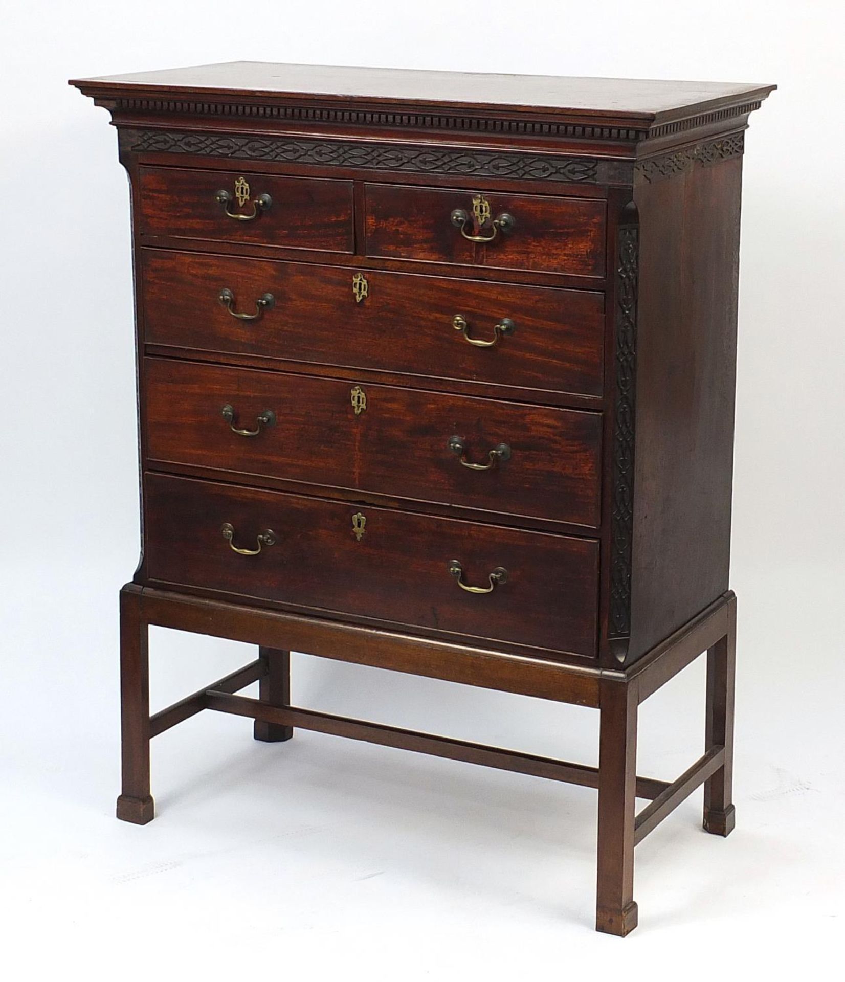 Antique mahogany five drawer chest on stand with blind fretwork, 147cm H x 116cm W x 57.5cm D :