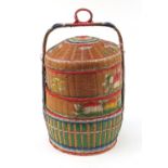 Oriental four section wicker food container hand painted with fish and flowers, 72cm high :