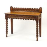 Victorian gothic style carved oak side table with bobbin turned legs, 95cm H x 107cm W x 44cm D :