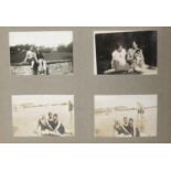 Early 20th century social history photographs arranged in two albums including beach scenes, railway