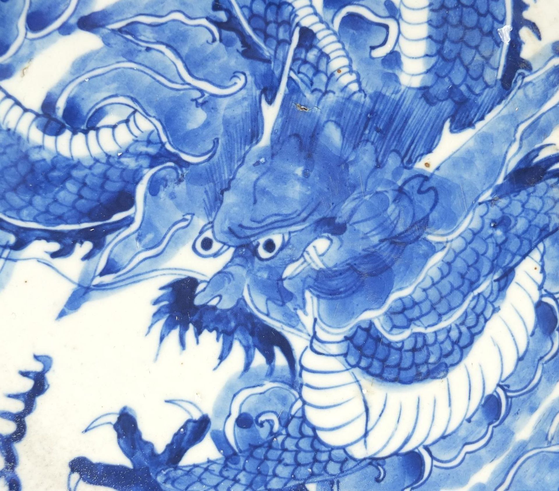 Chinese blue and white porcelain plate hand painted with a dragon amongst clouds chasing a flaming - Image 2 of 4