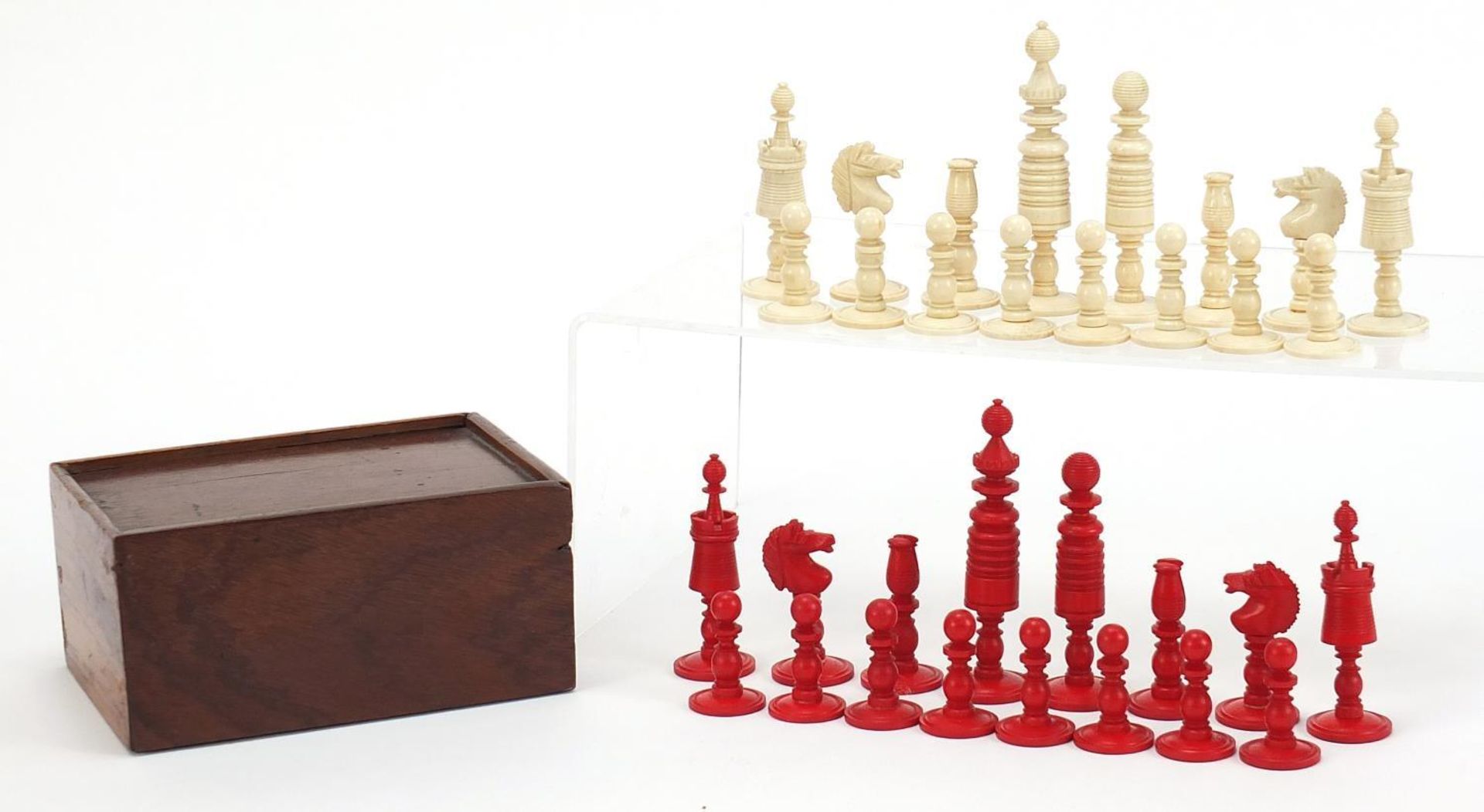 Carved bone half stained chess set with mahogany case, the largest pieces each 9cm high :