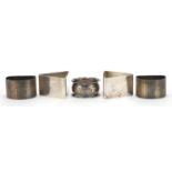 Two pairs of silver napkin rings and one other, the largest 3.2cm high, various hallmarks, total