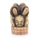 Japanese carved ivory netsuke of an acrobat, character marks to the base, 4.5cm in length :
