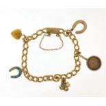 Unmarked gold bracelet with gold and silver charms, the bracelet tests as 18ct gold, total 23.0g :