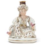 Jacob Petit, French porcelain figural candlestick of a Turkish female holding a bird and flower,
