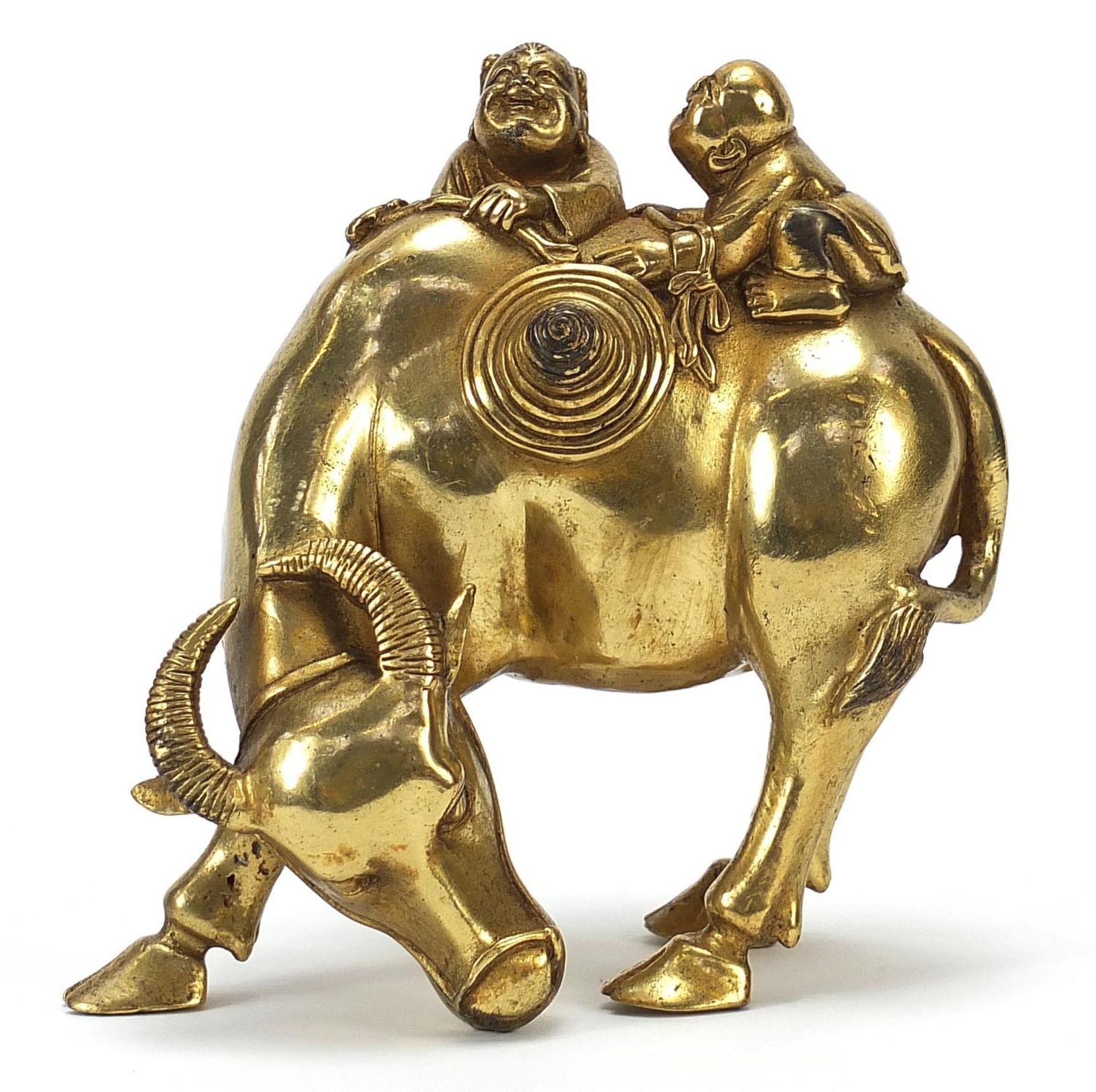 Chinese gilt bronze figure of two boys on a water buffalo, 14cm high :