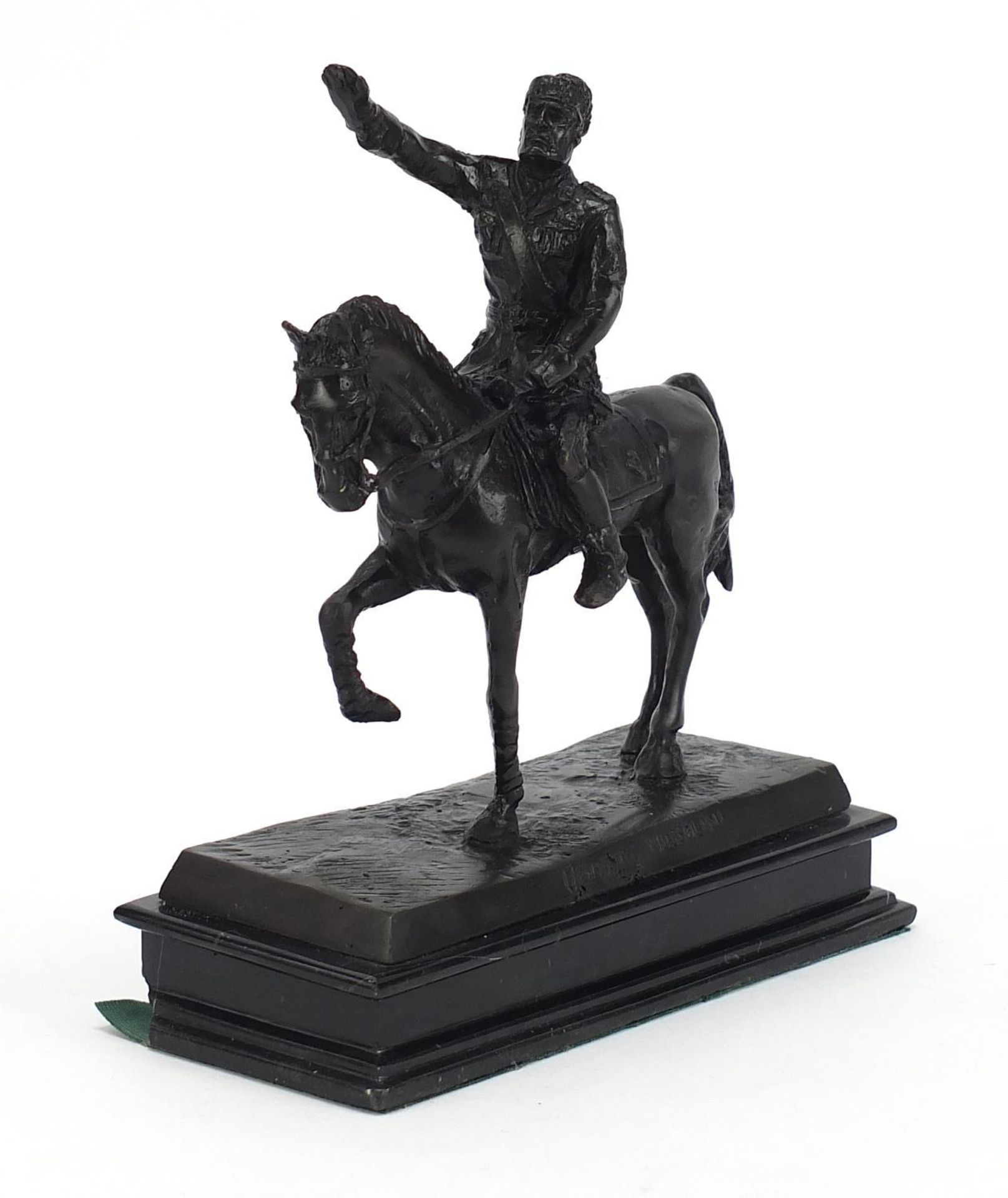 Patinated bronze study of an officer on horseback raised on a rectangular black marble base, 20.