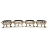 Set of four George III silver open table salts with grotesque masks and hoof feet, 5cm high x 9cm in