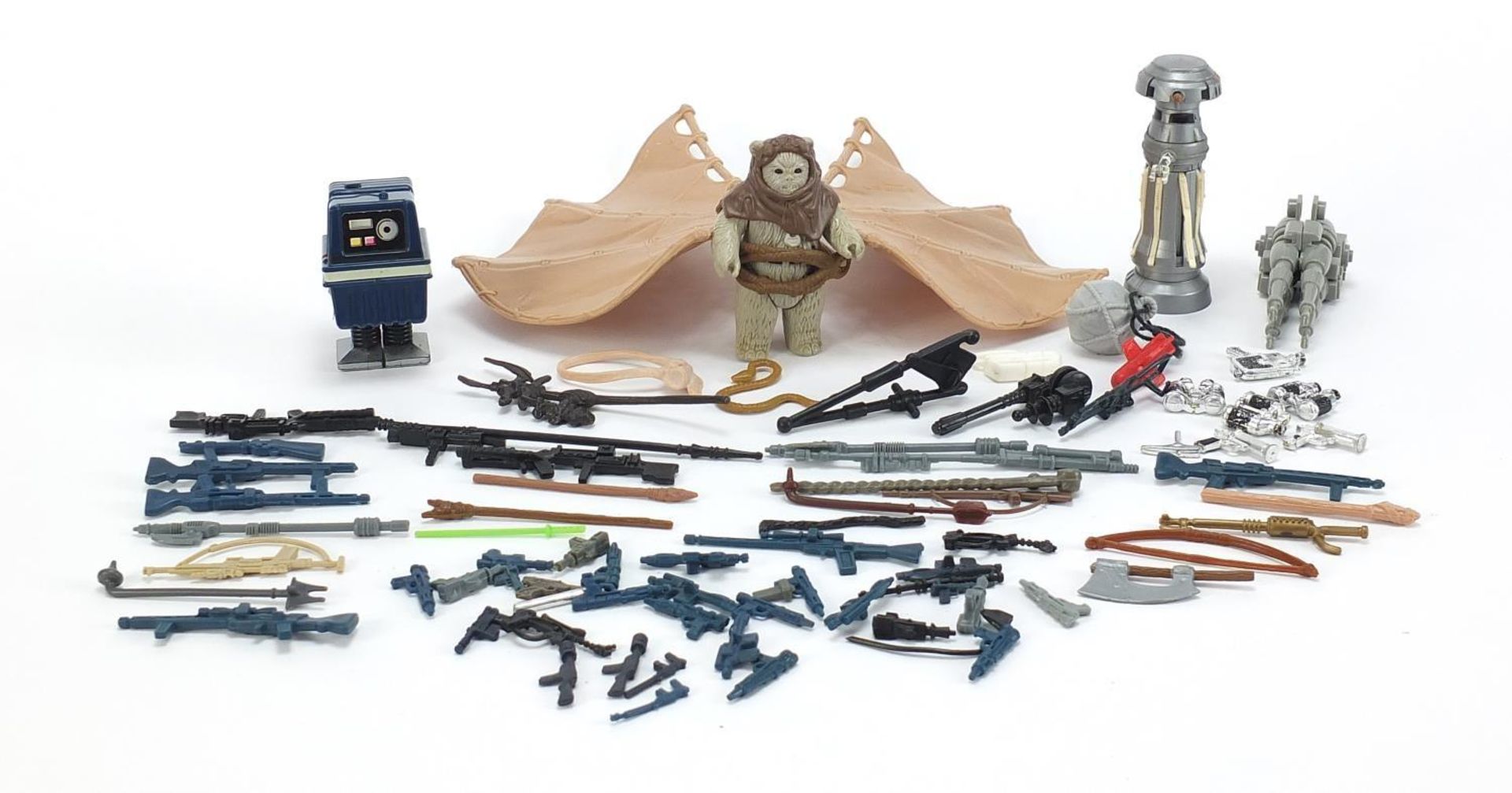 Collection of vintage Star Wars action figure accessories including guns and Ewok glider action