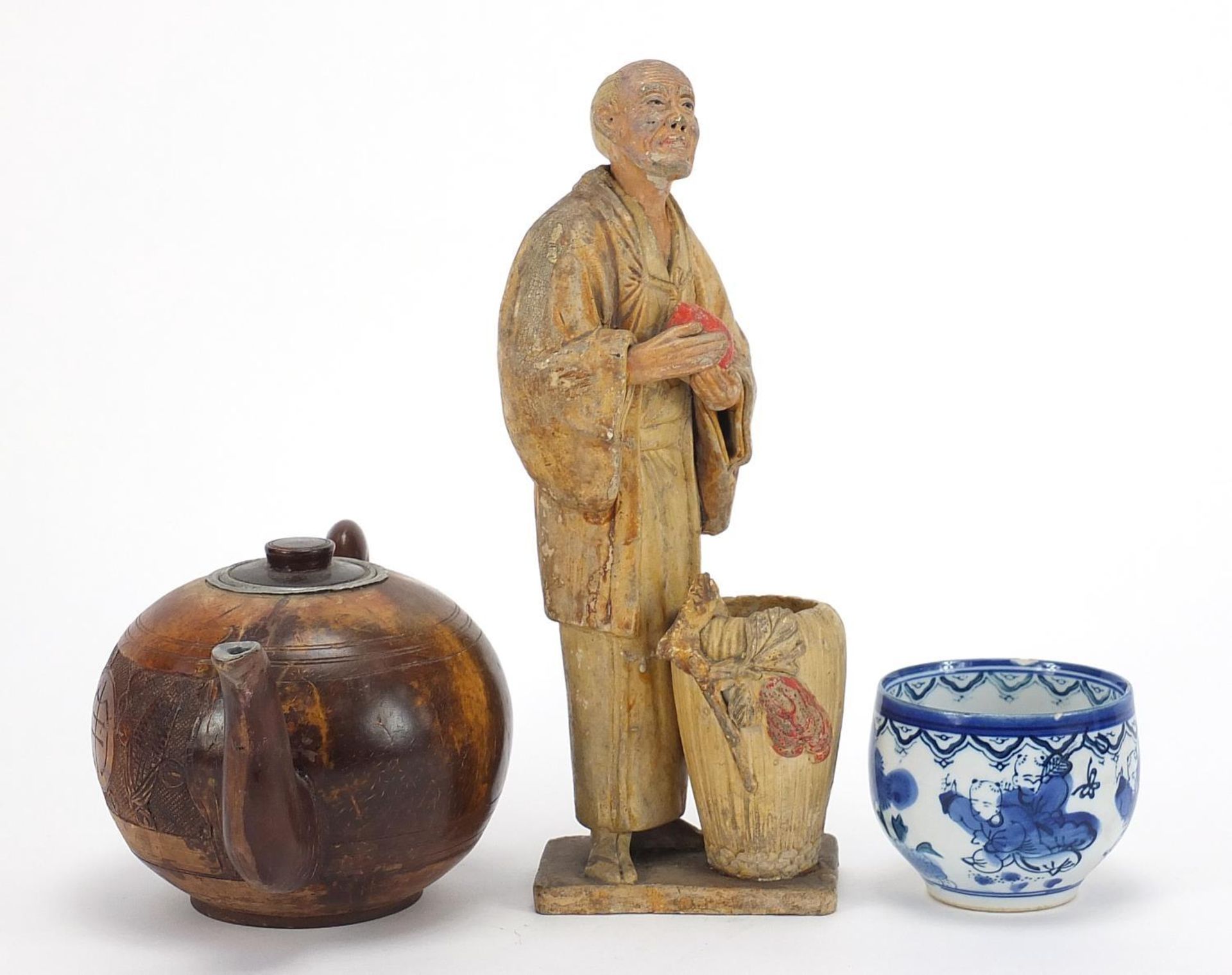 Oriental objects including a carved wood teapot and pottery figure of a man holding a peach, the - Image 2 of 9