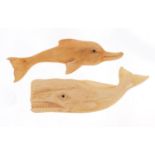 Two Scrimshaw style bone carvings of a whale and dolphin, the largest 8cm in length :